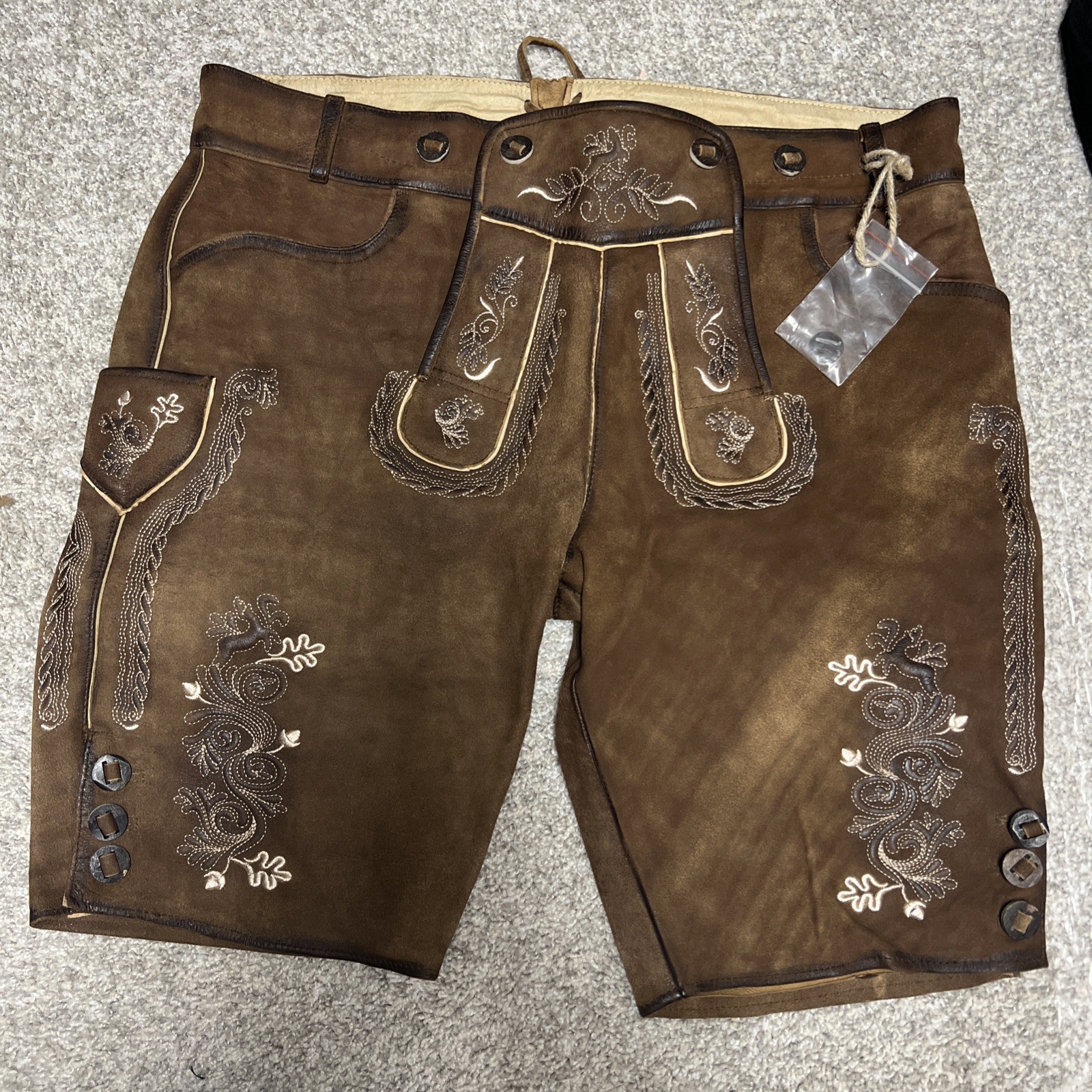 Bavarian Lederhosen leather shorts with intricate embroidery. Men’s US 34